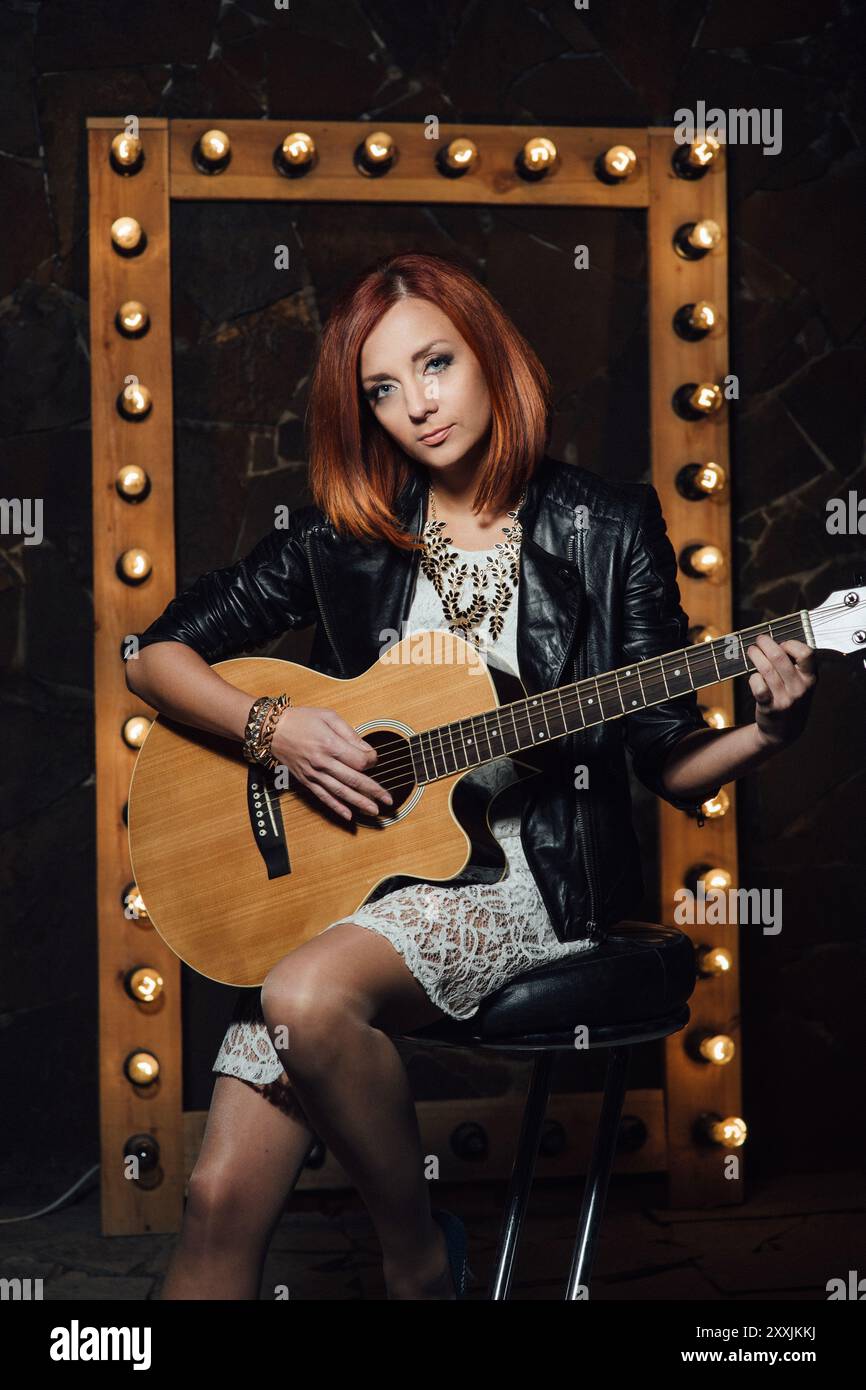 musician young girl with red hair with an acoustic guitar Stock Photo ...