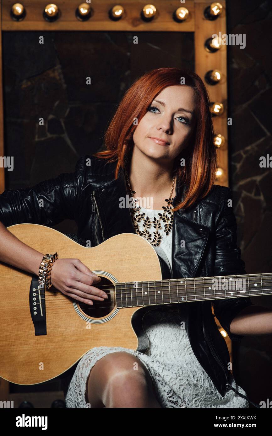musician young girl with red hair with an acoustic guitar Stock Photo ...