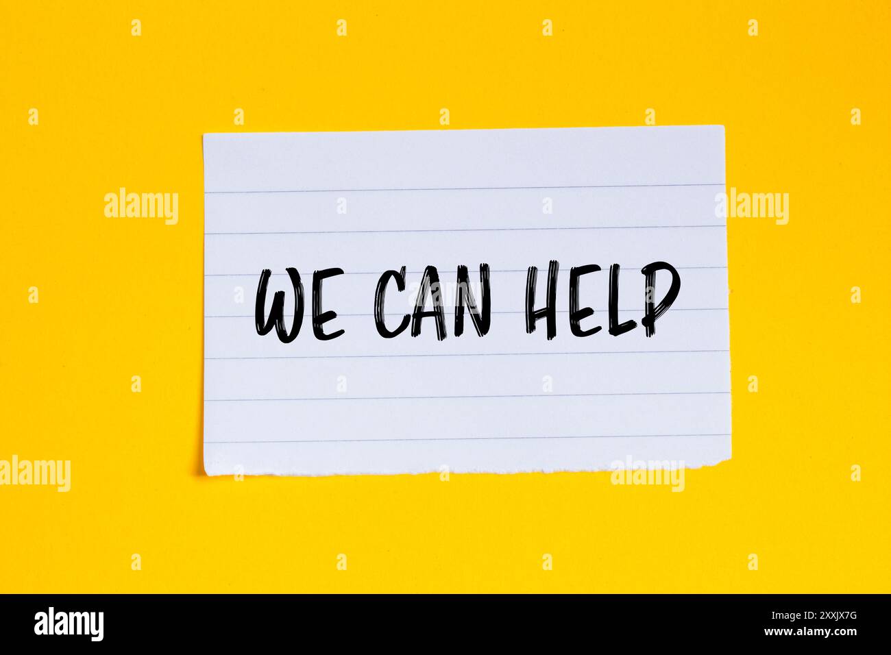 We can help message written on ripped white paper piece with yellow ...