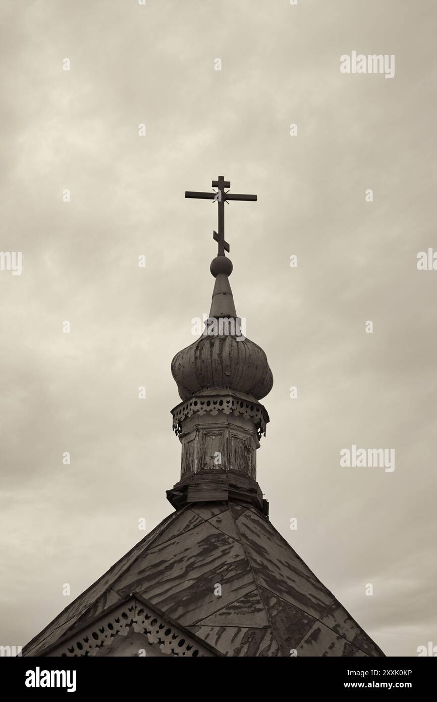 Orthodox cross on top of church. Monochrome image with sepia effect Stock Photo