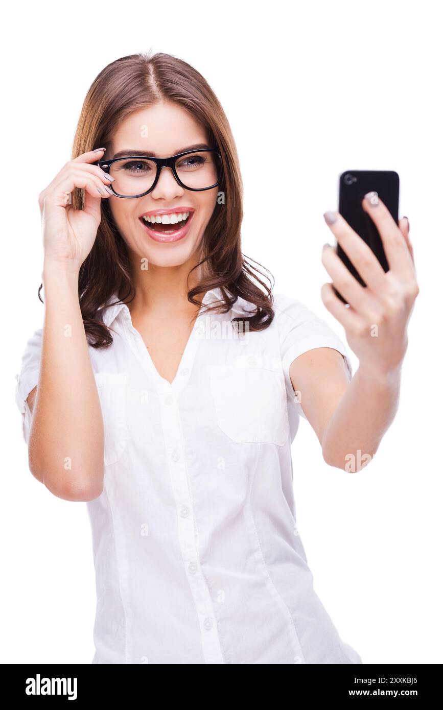 Selfie! Attractive young woman holding mobile phone and making photo of ...