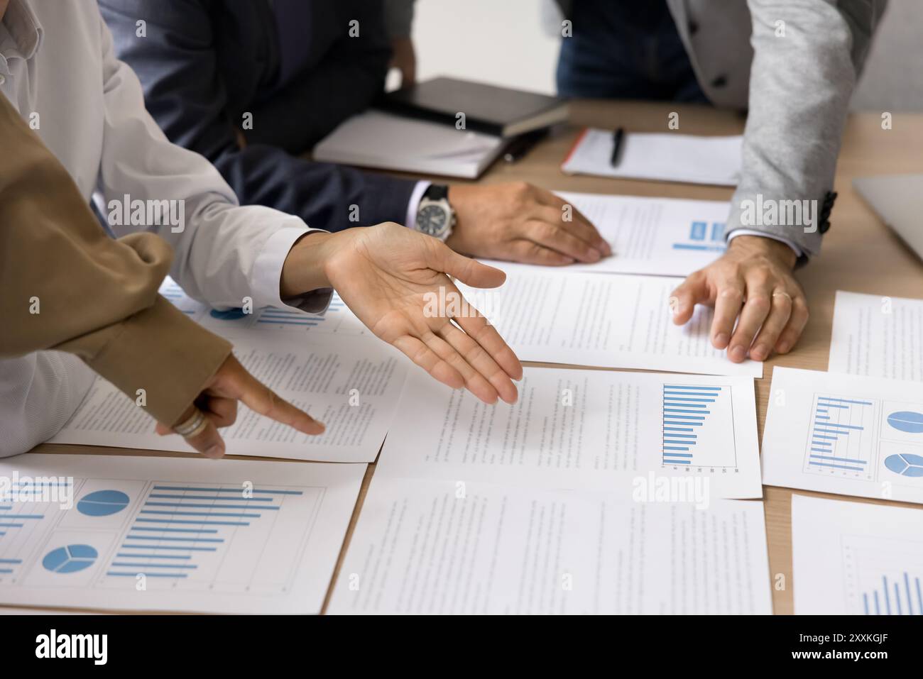 Businesspeople planning strategy based on data, engaged in teamwork, closeup Stock Photo