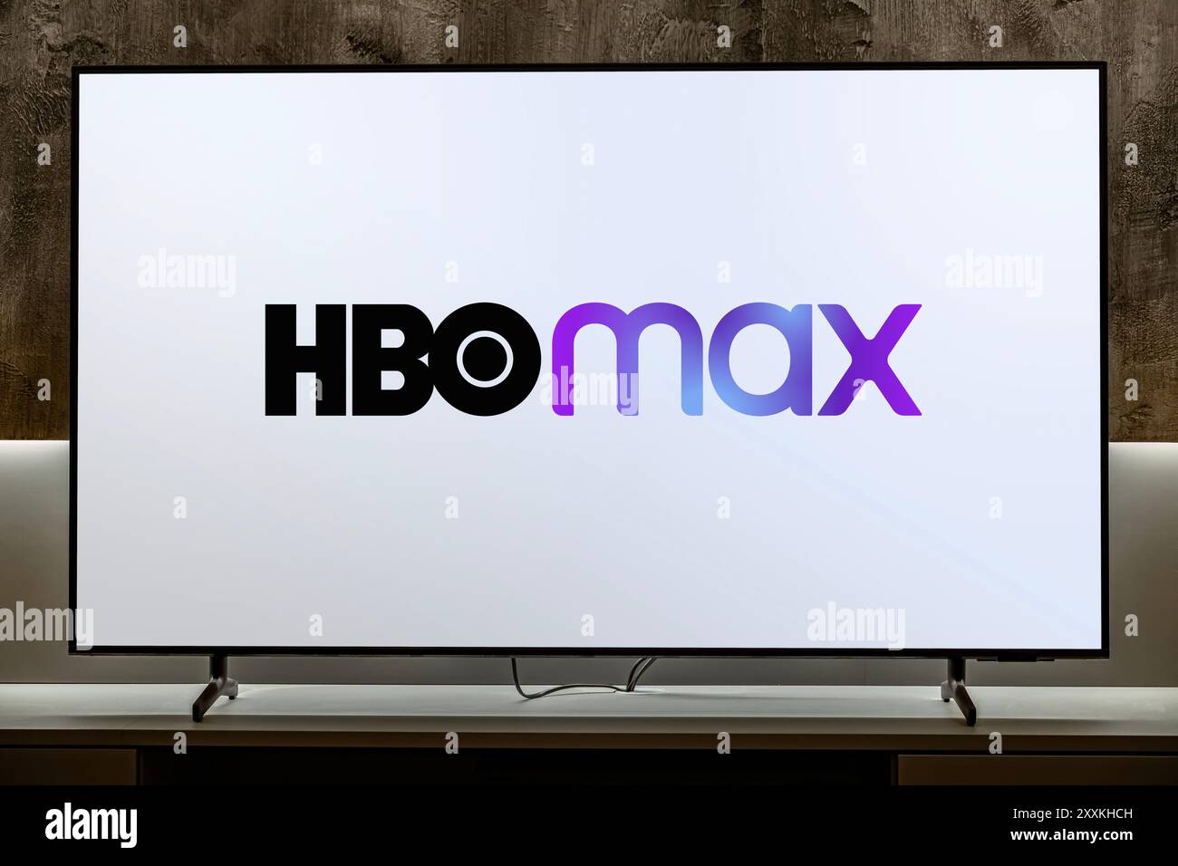 POZNAN, POL - DEC 19, 2023: Flat-screen TV set displaying logo of HBO Max, an American subscription video on demand streaming service owned by AT&T Stock Photo