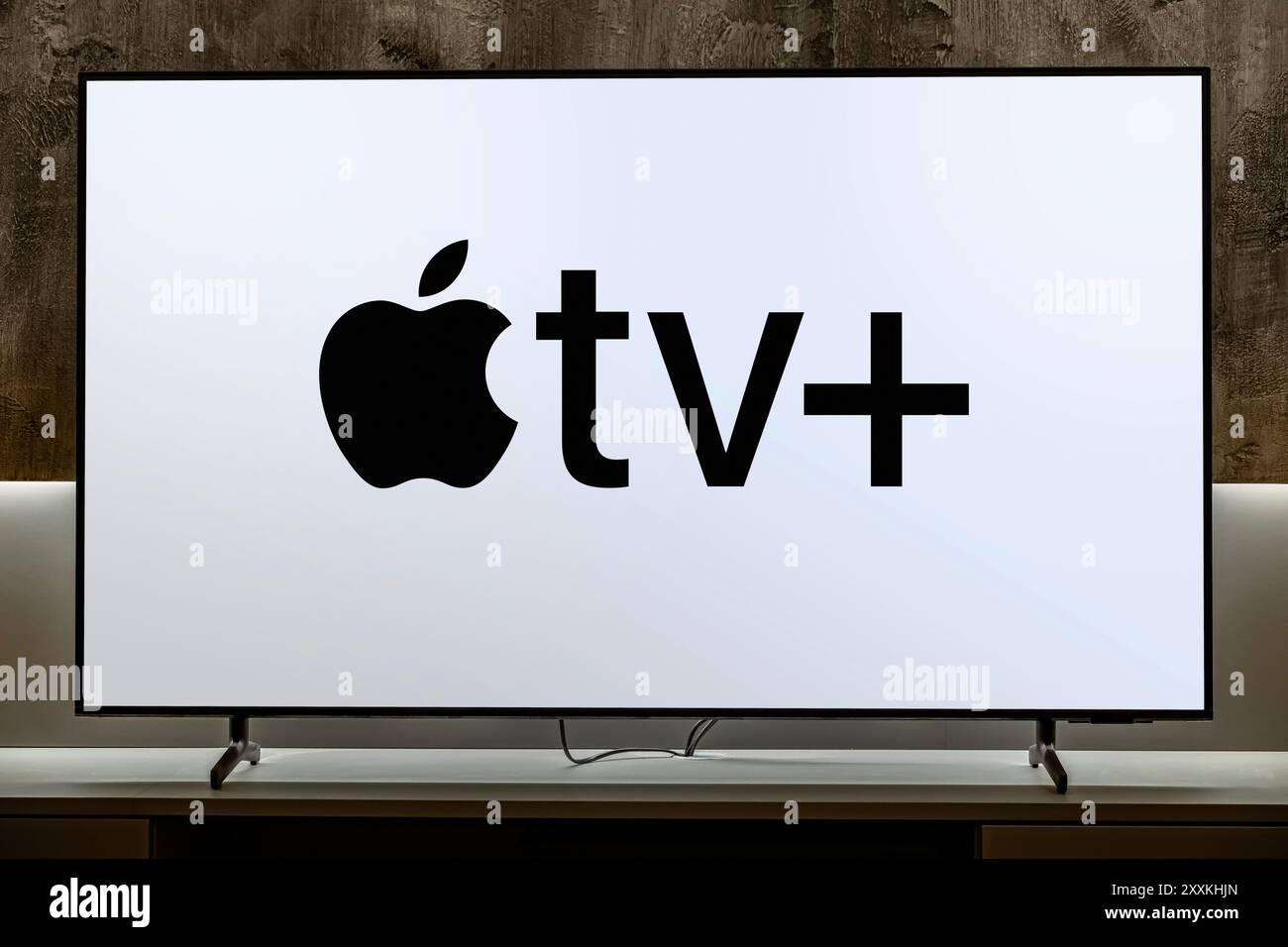 POZNAN, POL - DEC 19, 2023: Flat-screen TV set displaying logo of Apple ...