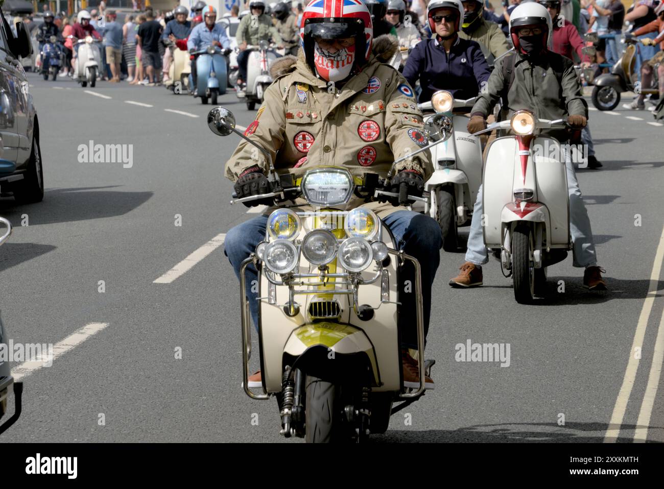A man riding a vintage scooter at the Isle of Wight, United Kingdom ...
