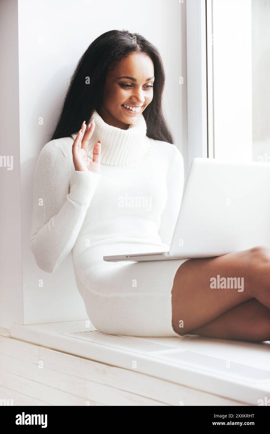Happy african woman waving hand hi-res stock photography and images - Alamy