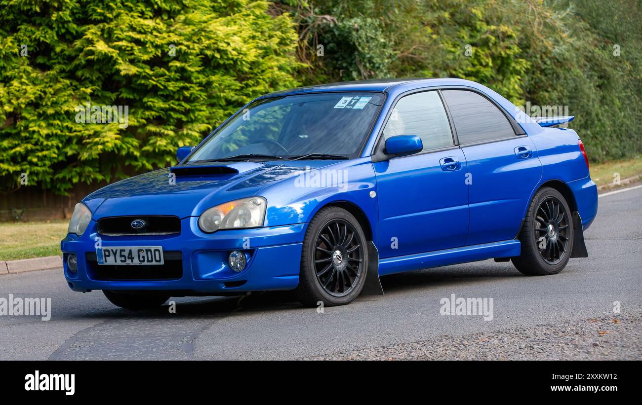 Whittlebury,Northants.,UK - Aug 25th 2024: 2004 blue Subaru Impreza classic car driving on a British country road. Stock Photo