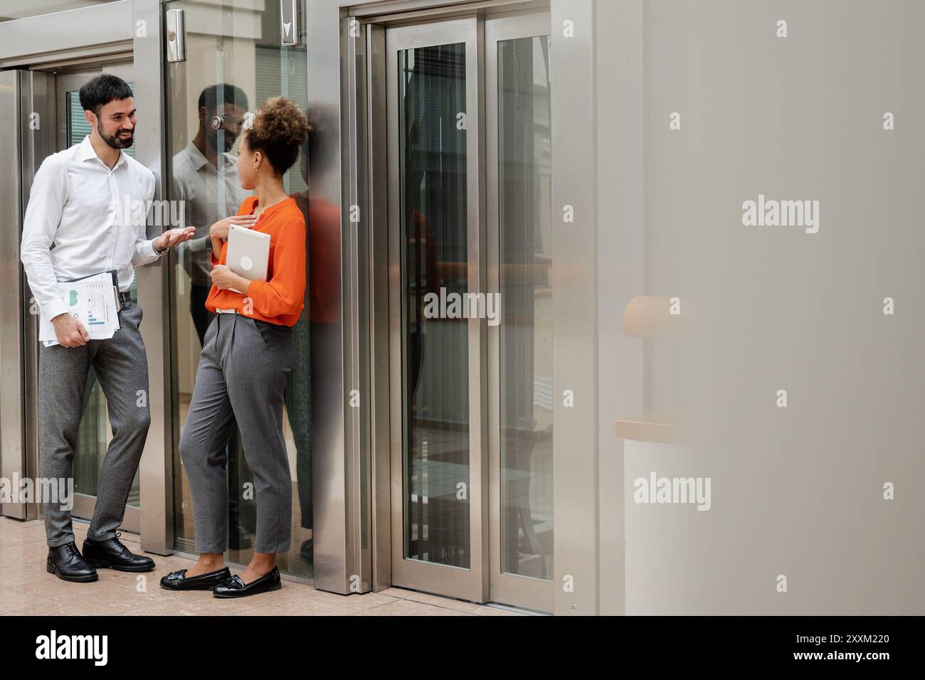 Two 30s colleagues discussing presentation, prepare collaborative on-line project Stock Photo