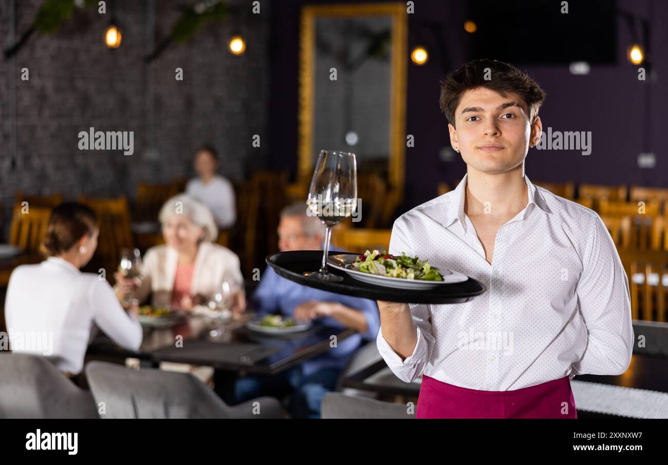 Smiling waiter posing food tray hi-res stock photography and images - Alamy