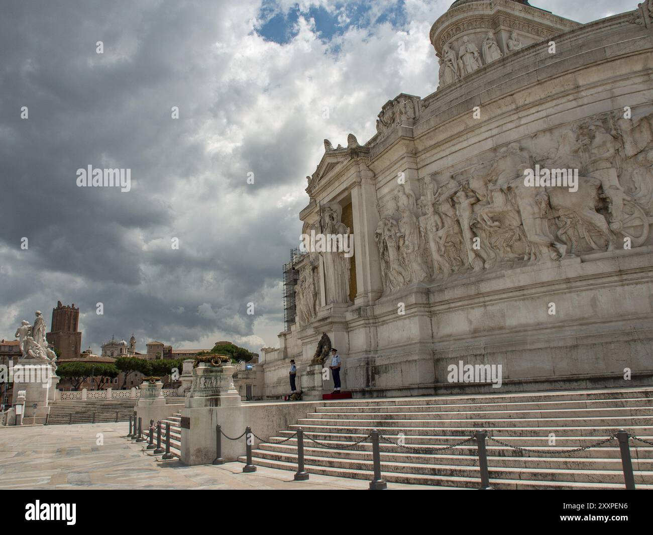 Statue Rome Side View Side view of a massive monument with reliefs and steps under a dramatic ...