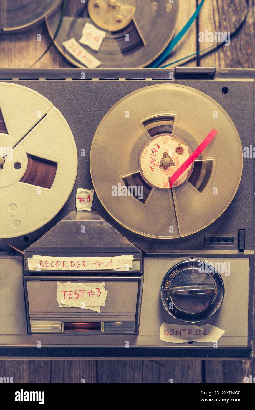 Classic reel audio recorder and a used rolls of tape. Recording reeltoreel tape recorder with