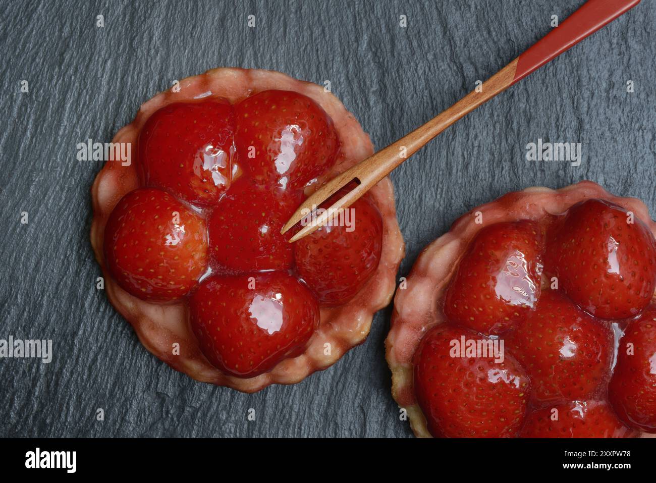 Topped strawberry tarts with a fork Stock Photo