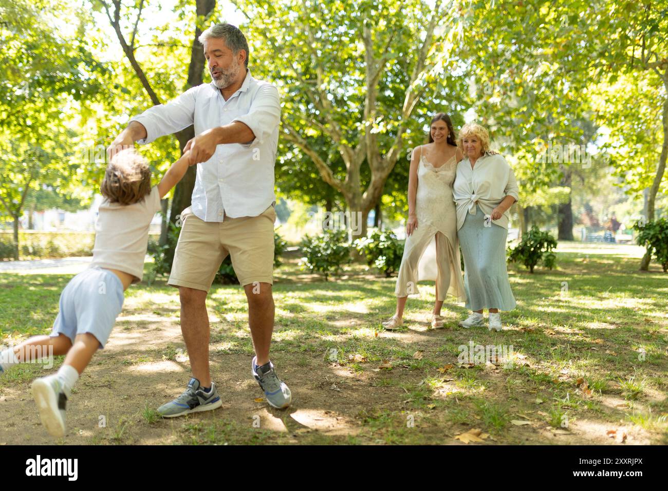 Happy family having fun, playing together in the park Stock Photo - Alamy