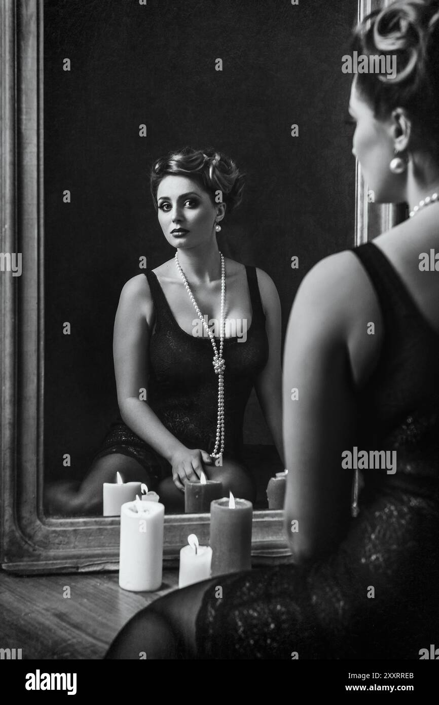 young brunette model girl and actress in front of a mirror, black and ...