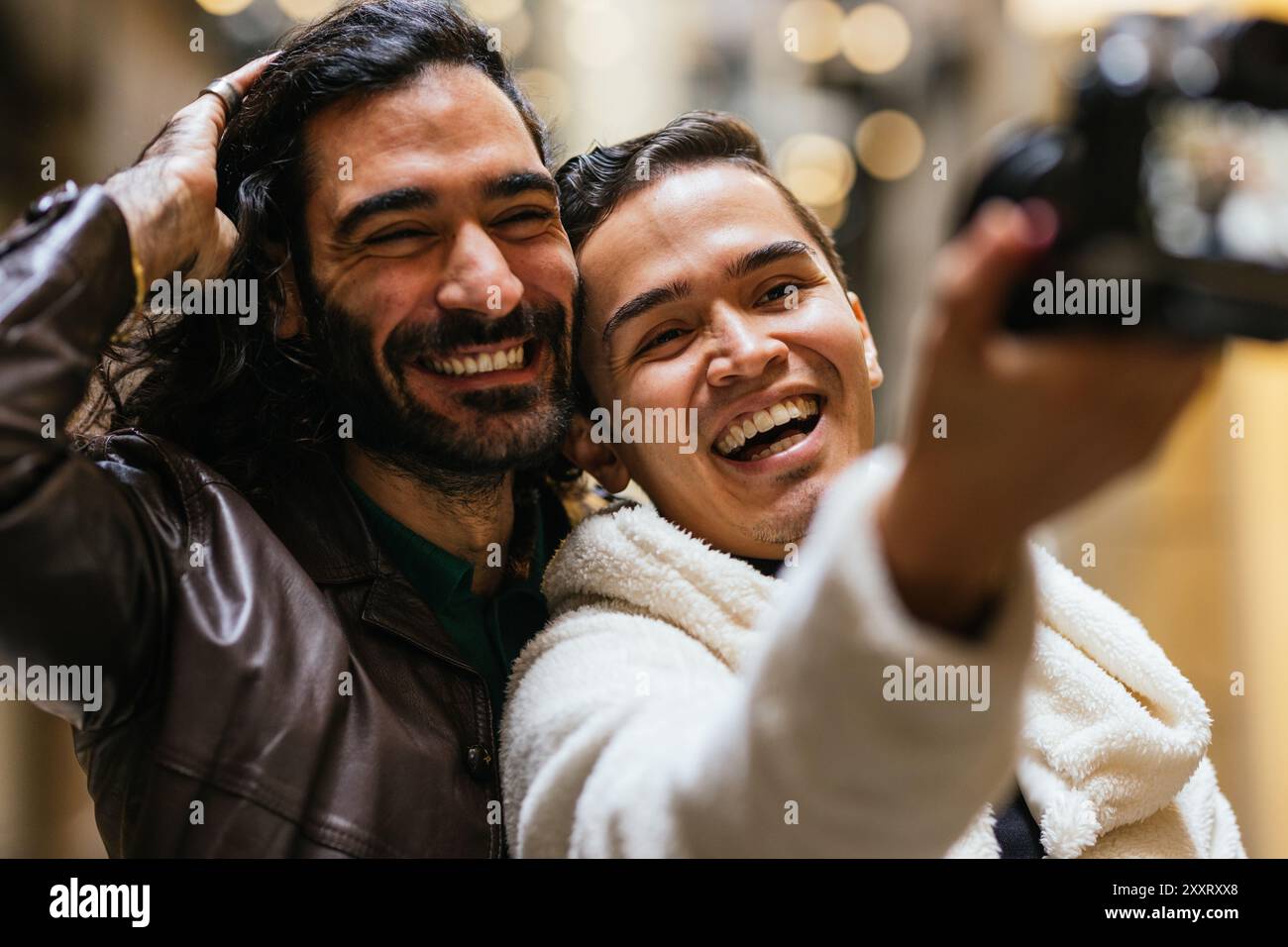 Two happy men taking a selfie while smiling and having fun Stock Photo