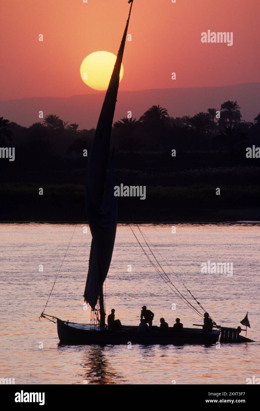 Boat sails on the Nile River at sunset near Luxor, Egypt Stock Photo ...