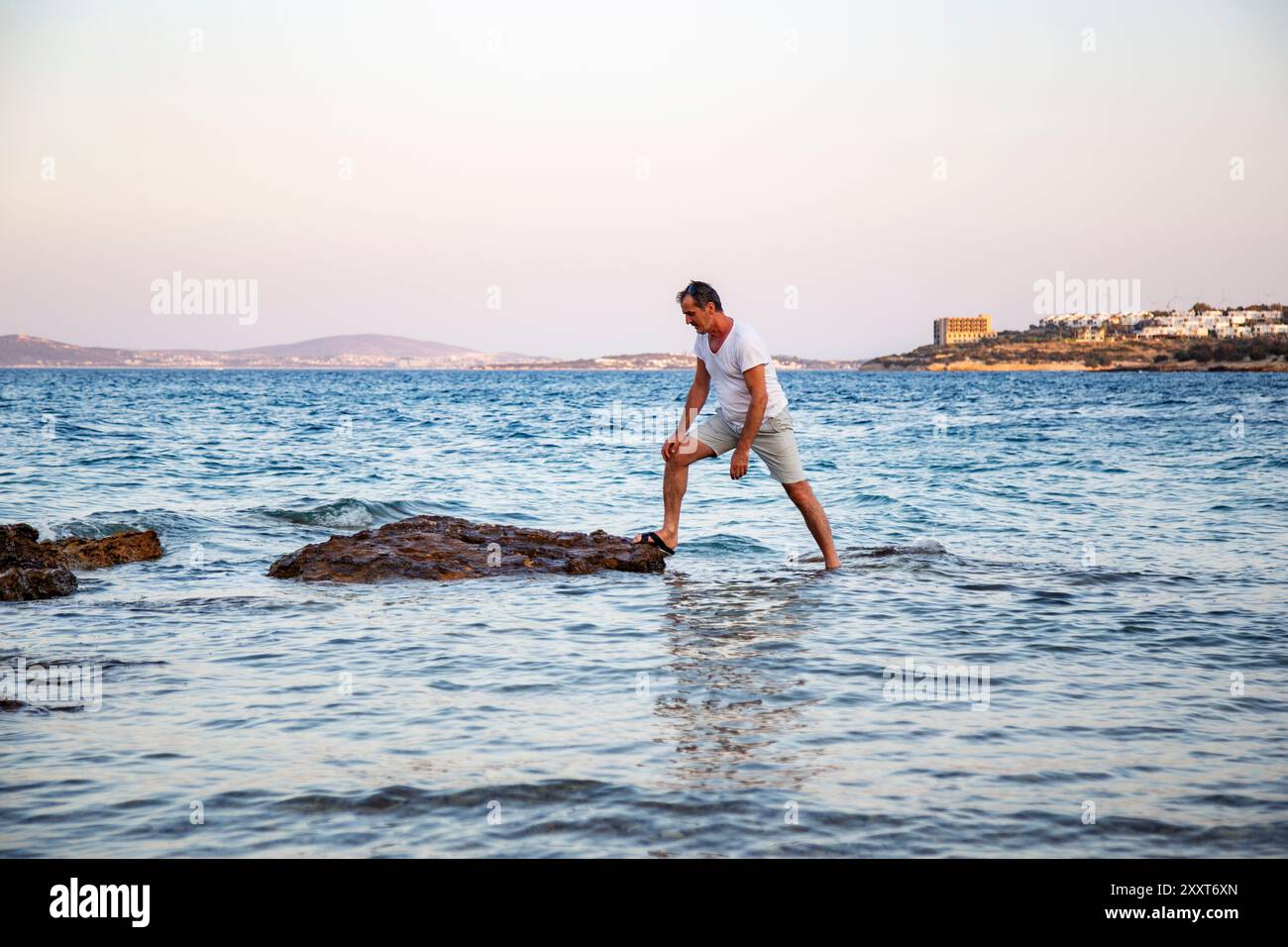 People Exploring Rocks Man exploring coastal rocks in the sea, steps over rocks Stock Photo ...