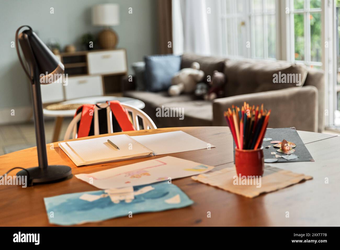 Table desk with lamp, papers, drawings and colored pencils Stock Photo ...