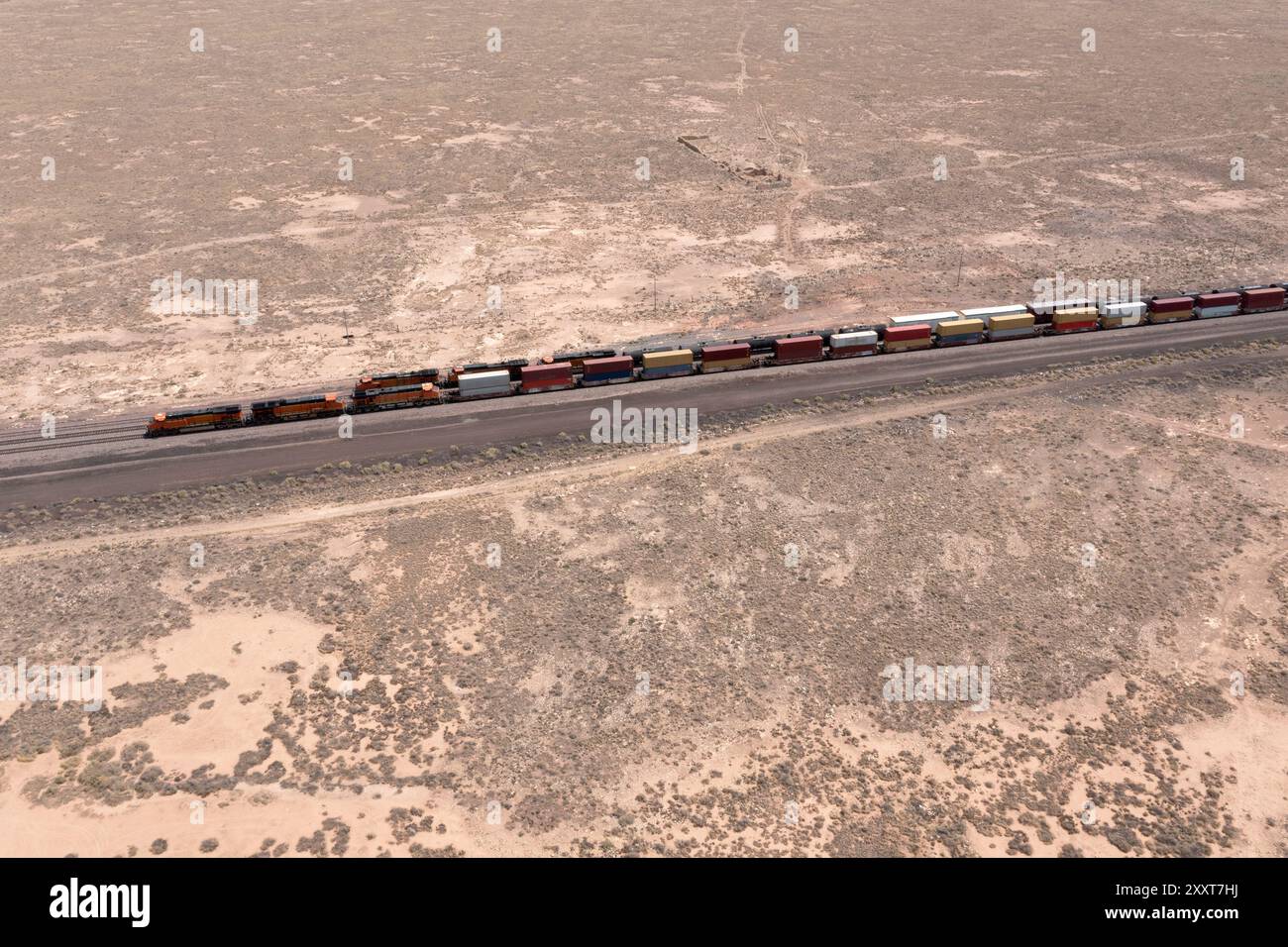 Parallel freight trains in a remote desert environment wide view Stock Photo