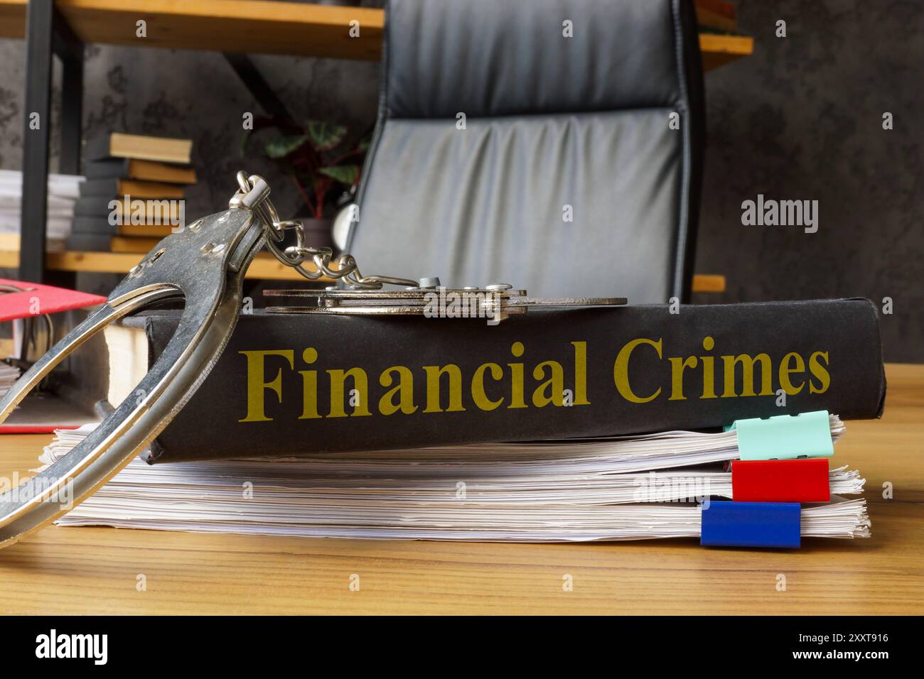 Book financial crimes with handcuffs on it. Legal consequences and economic fraud. Stock Photo