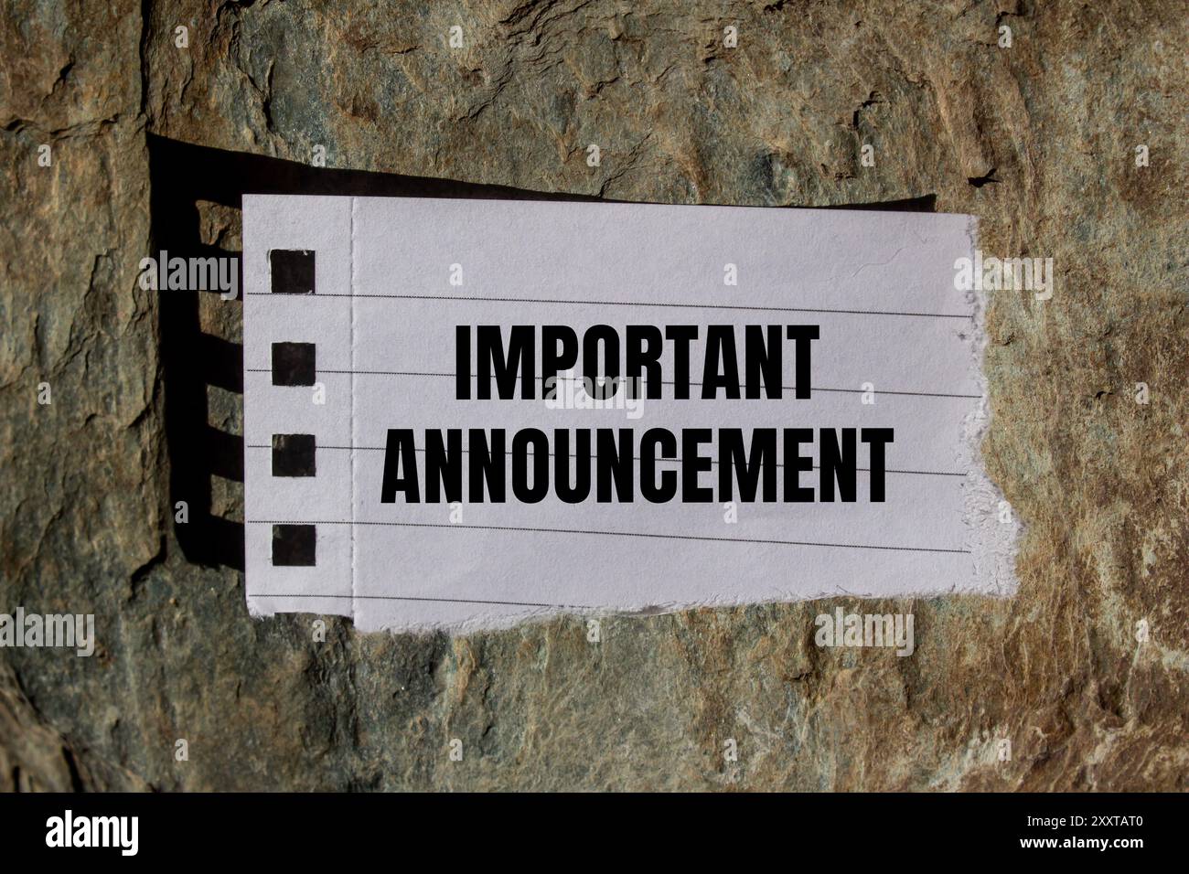 Important announcement message written on ripped torn paper piece with ...