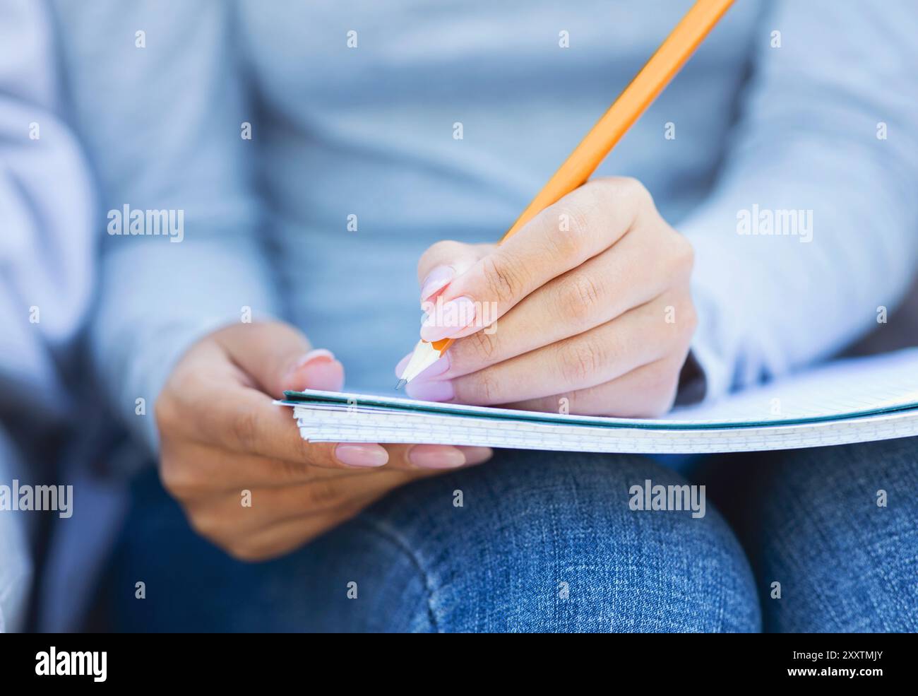Cropped of student girl taking notes, using notepad and pencil Stock ...