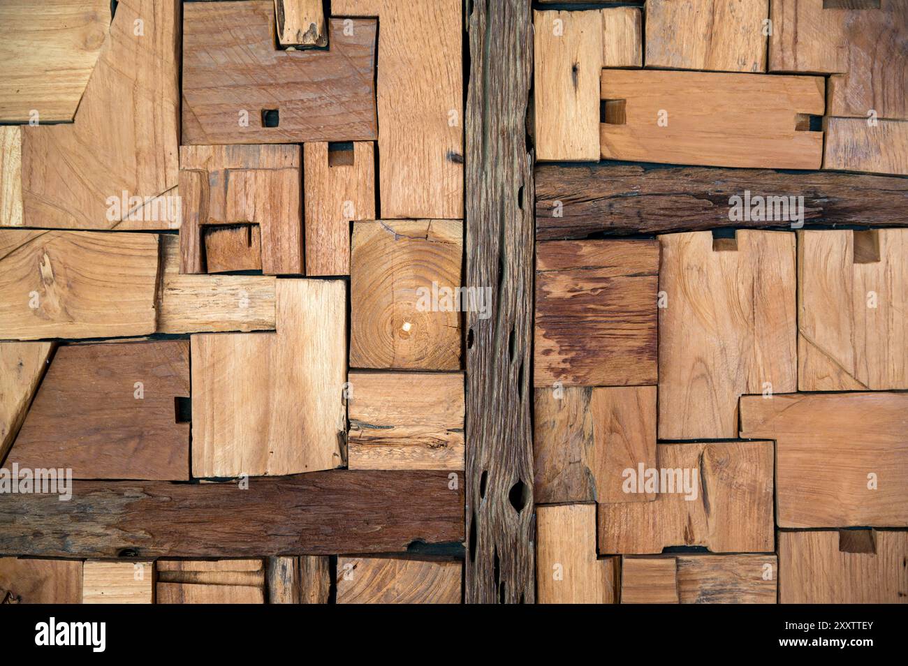 Abstract wooden background surface texture with irregular woods of uneven sizes colors and grains arranged in random geometric pattern in daylight Stock Photo