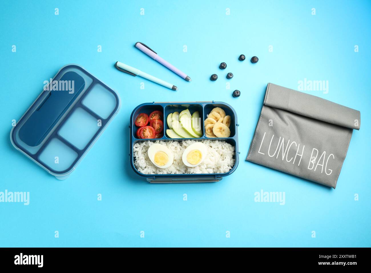 Bag, lunch box with snacks and pens on light blue background, flat lay ...