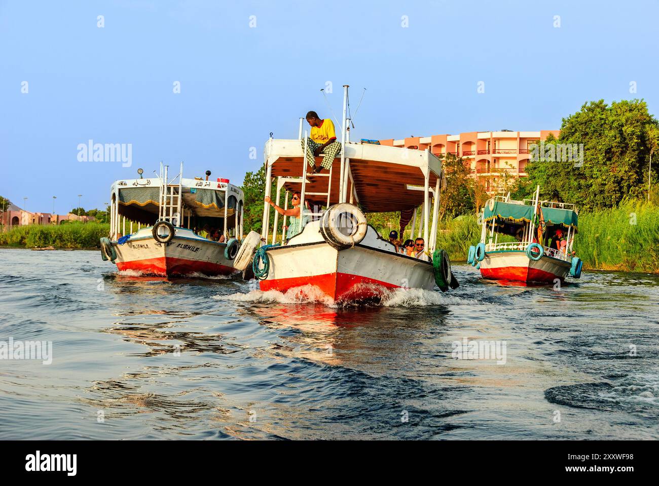 Boats with tourists on the Nile river - Aswan, Upper Egypt Stock Photo ...