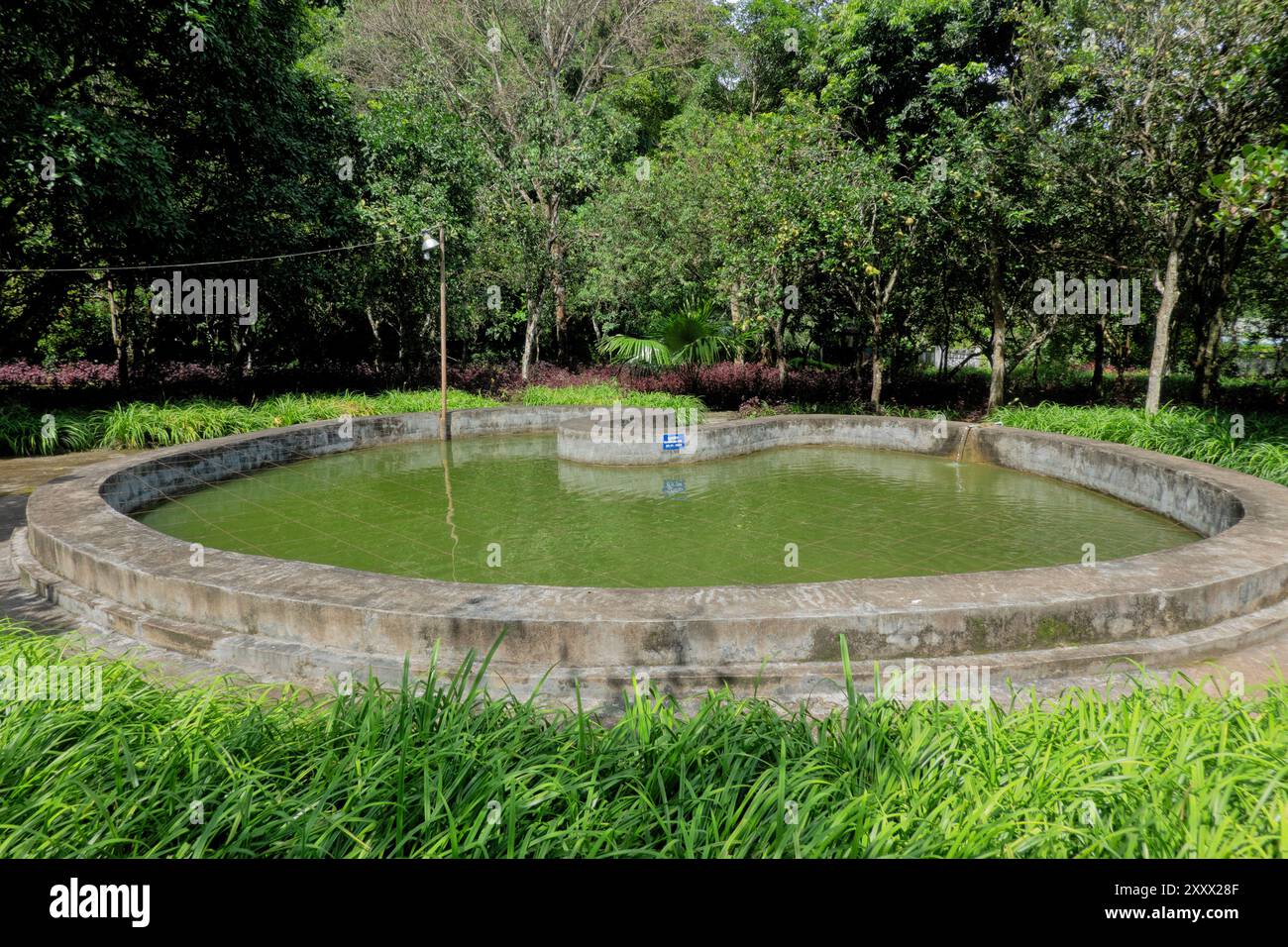 Old bomb crater turned to fish pond at the Vieng Xai Caves, Viengxay, Houaphanh, Laos Stock Photo