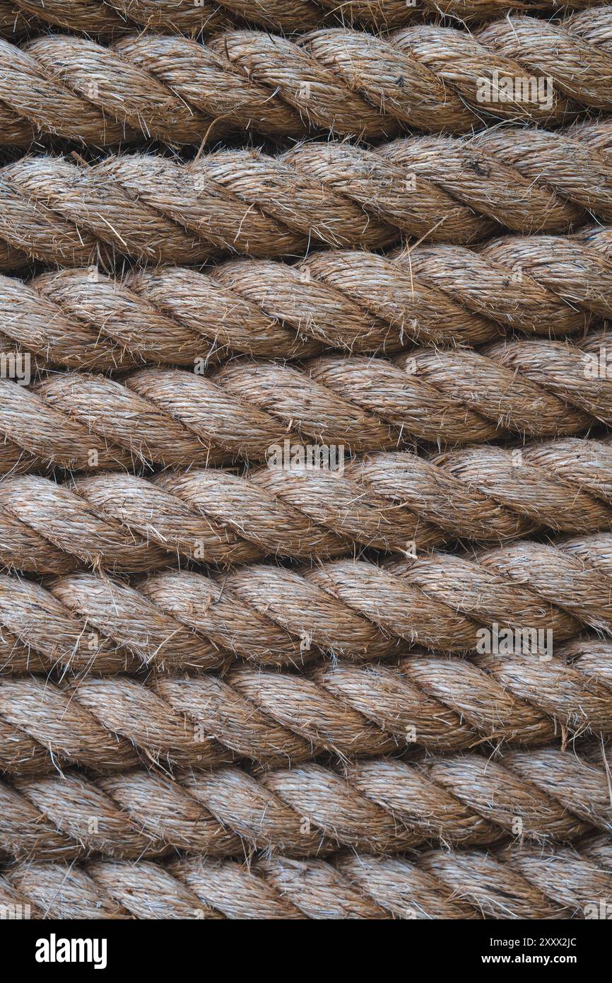 Thread Wrapped Around Rope A full frame background of thick shipping rope tightly wrapped together ...