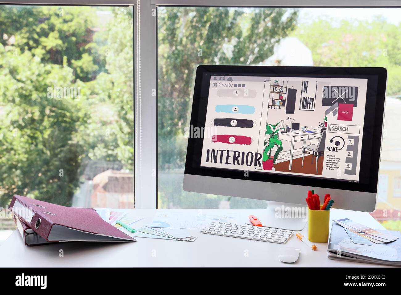 Graphic designer's workplace with computer and color palettes in office ...