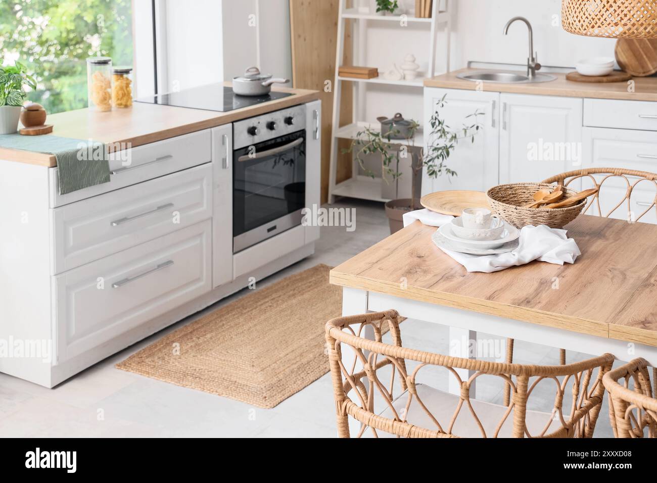 Interior of light kitchen with dining table and counters Stock Photo ...