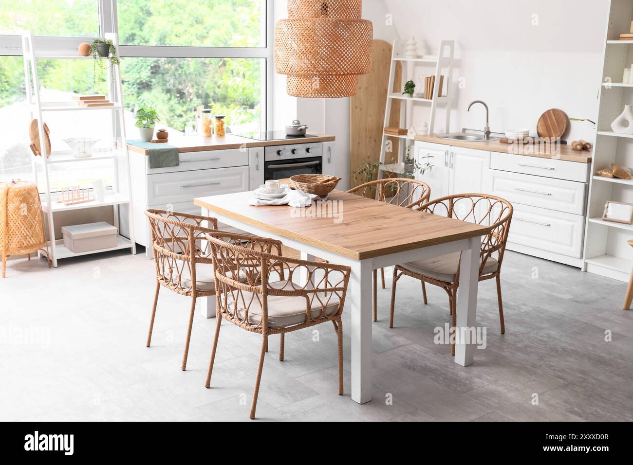 Interior of light kitchen with dining table, counters and shelf units ...
