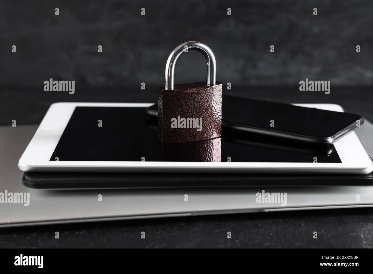 Modern gadgets with padlock on dark background, closeup. Cyber security ...