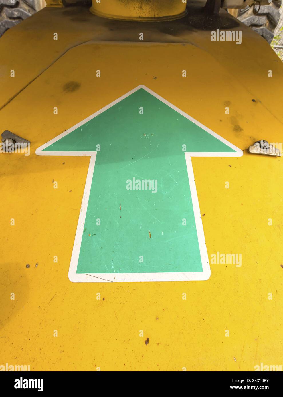 Green arrow pointing upwards on a machine Stock Photo