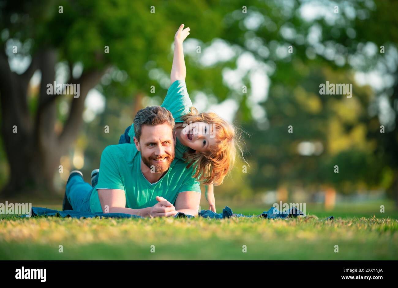 Father son lay on grass hi-res stock photography and images - Alamy