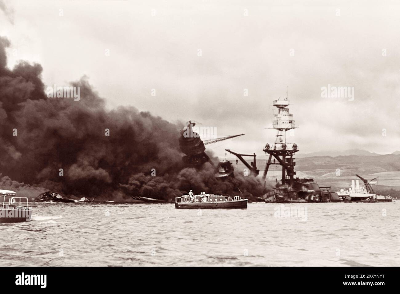 USS Arizona burning in Pearl Harbor after the aerial attack by the Empire of Japan on December 7,1941, on Oahu, Territory of Hawaii. Stock Photo