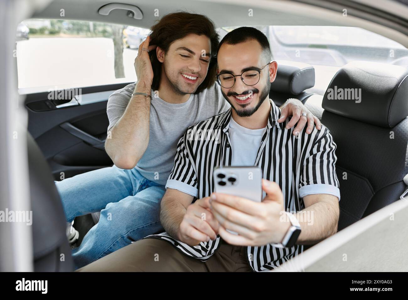 A gay couple spends time together in the backseat of a car Stock Photo ...