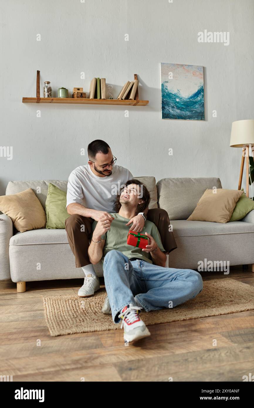 Gay couple enjoys heartwarming moment with gift Stock Photo