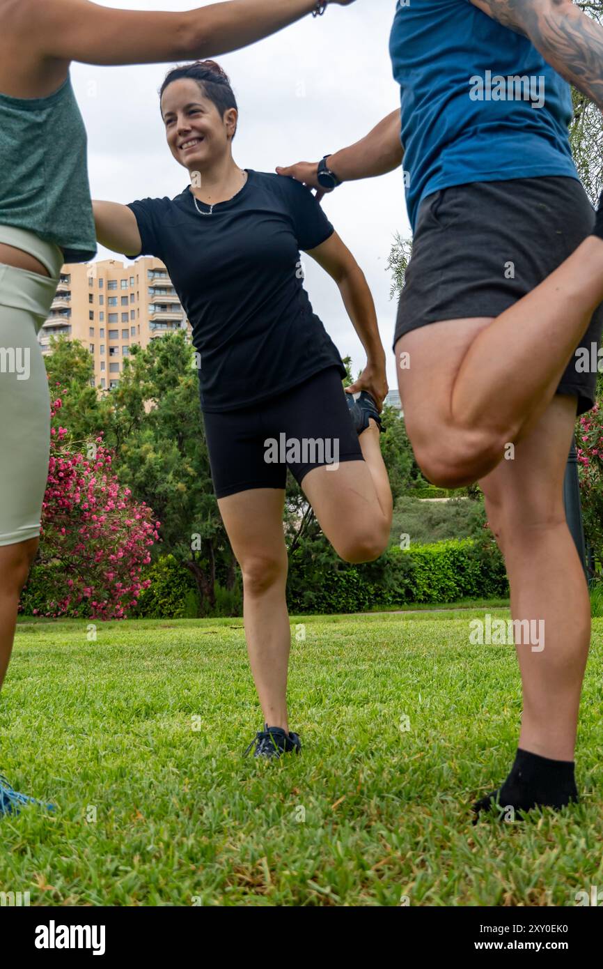 Team Let's Stretch A group of young athletes stretch their legs outdoors, integrating ...