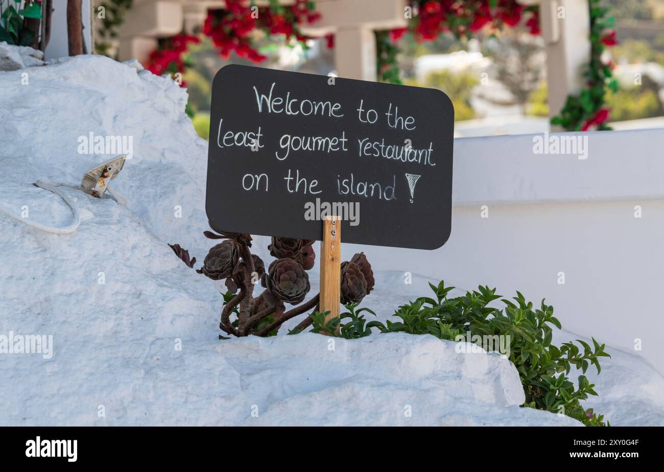 Baboulas Restaurant, Mykonos, Greece with sign Welcome to the least gourmet restaurant on the island Stock Photo