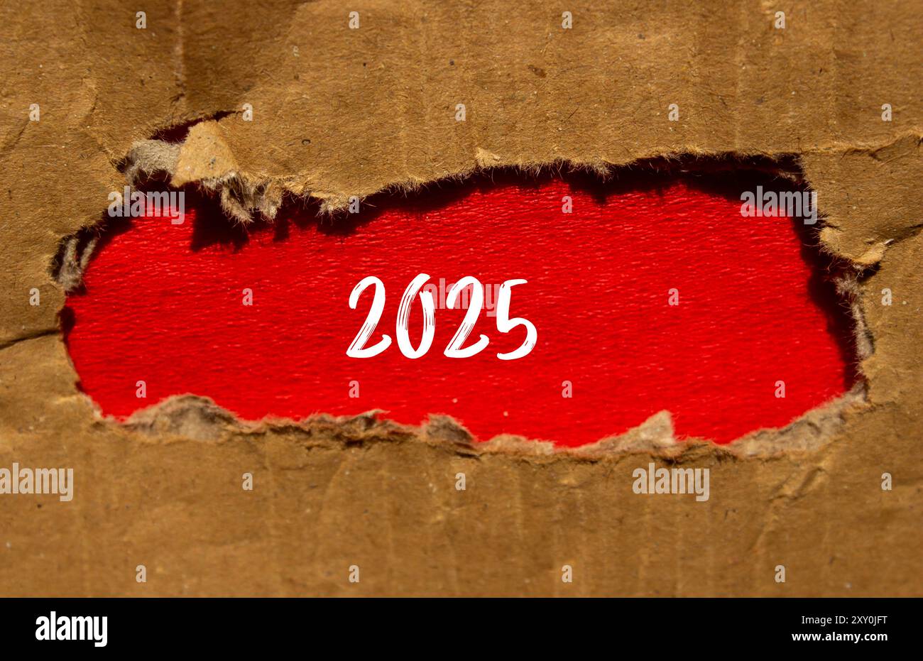 2025 message written on torn cardboard paper with red background