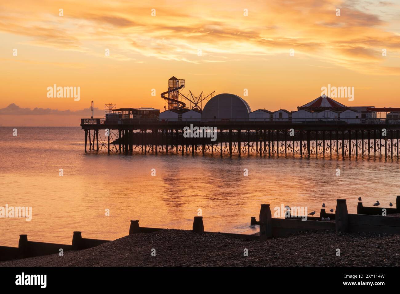 England, Kent, Herne Bay, Dawn over Sea and Pier in Background Stock Photo