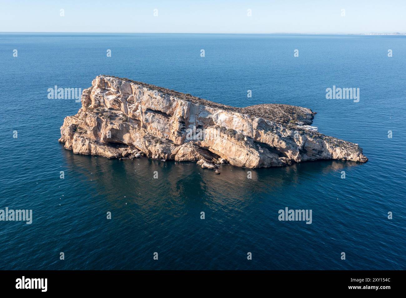 Aerial drone photo of the town of Benidorm in Spain showing the rock in the middle of the ocean known as Isla de Benidorm or Mirador de l'Illa de Beni Stock Photo