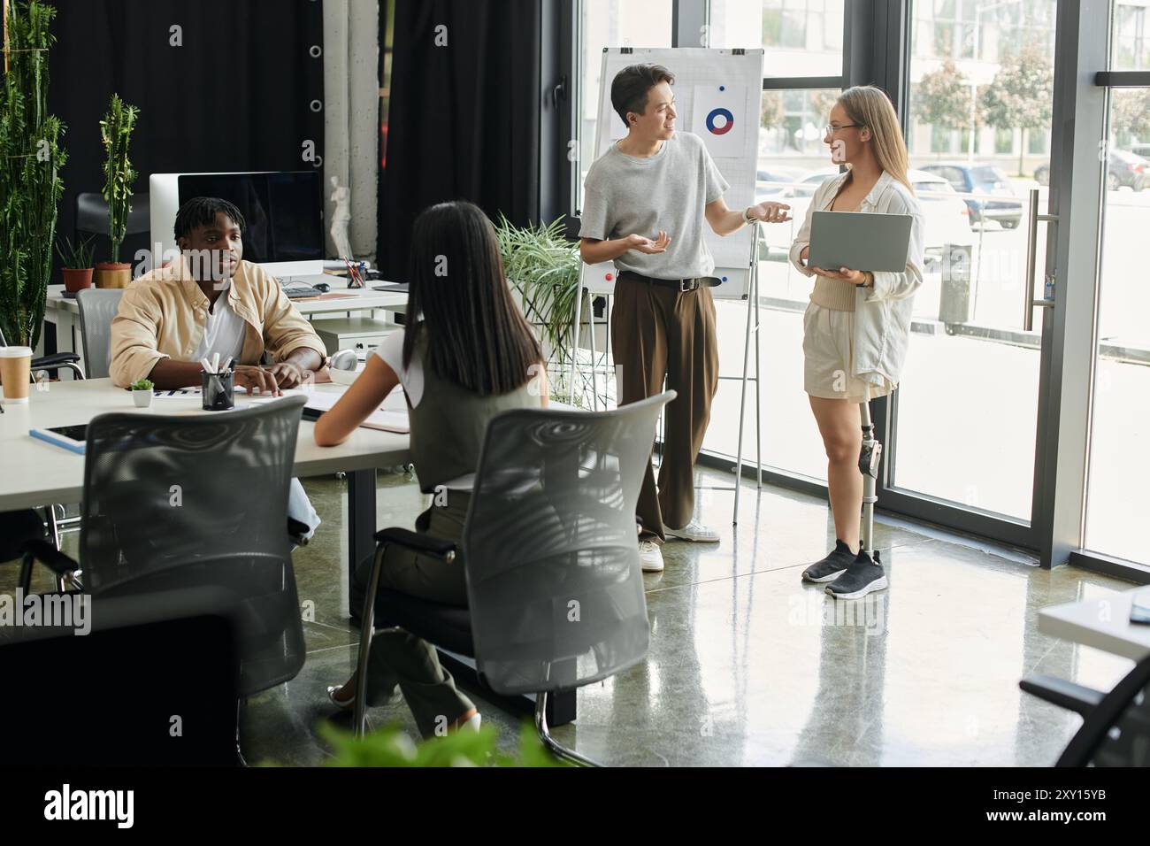 A diverse startup team collaborates in a modern office. Stock Photo