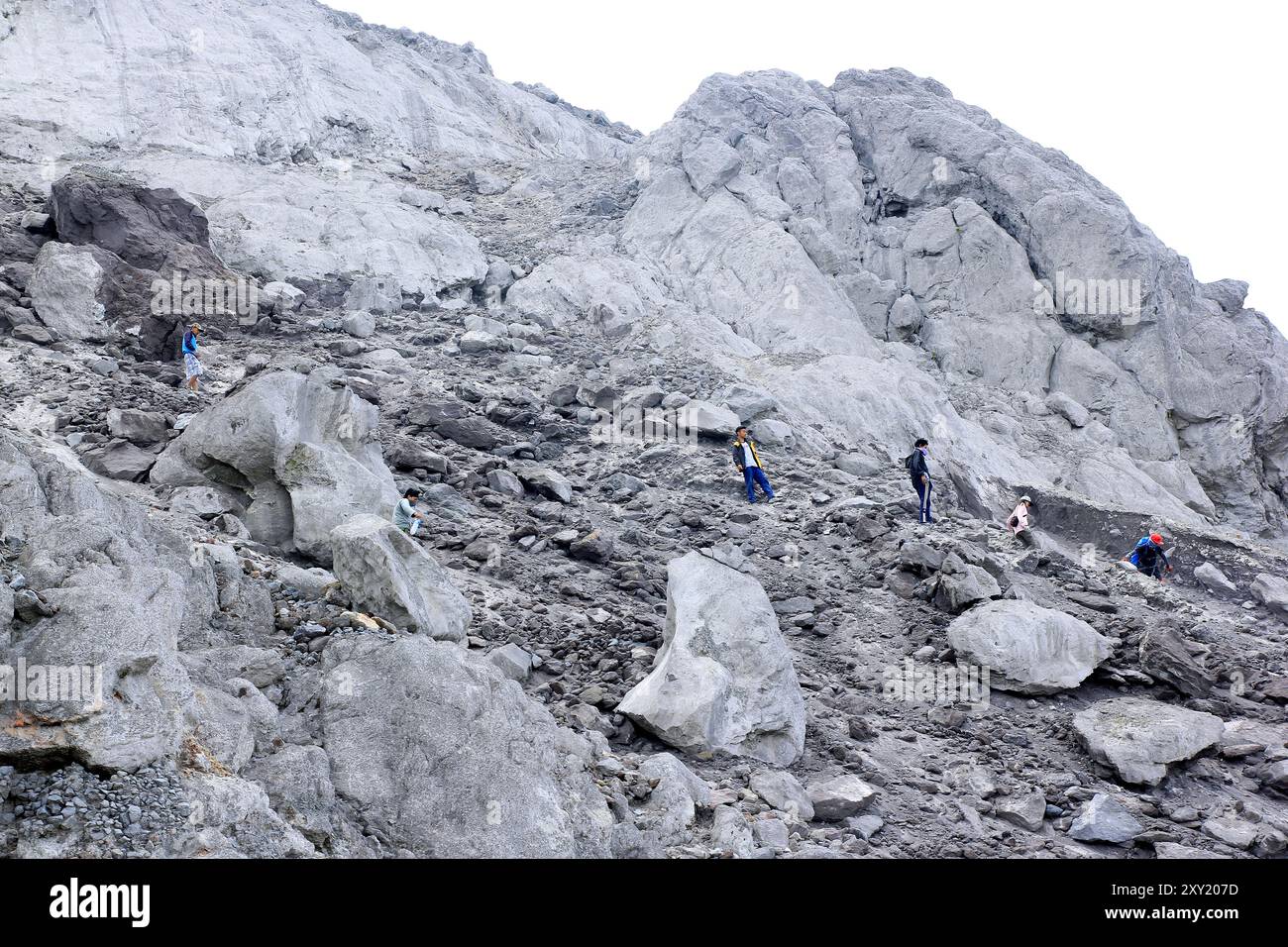 Climbers descend wall peak of Merapi, which is formed from lava material. Caution is needed, because character of fragile rocks and prone to landslide Stock Photo