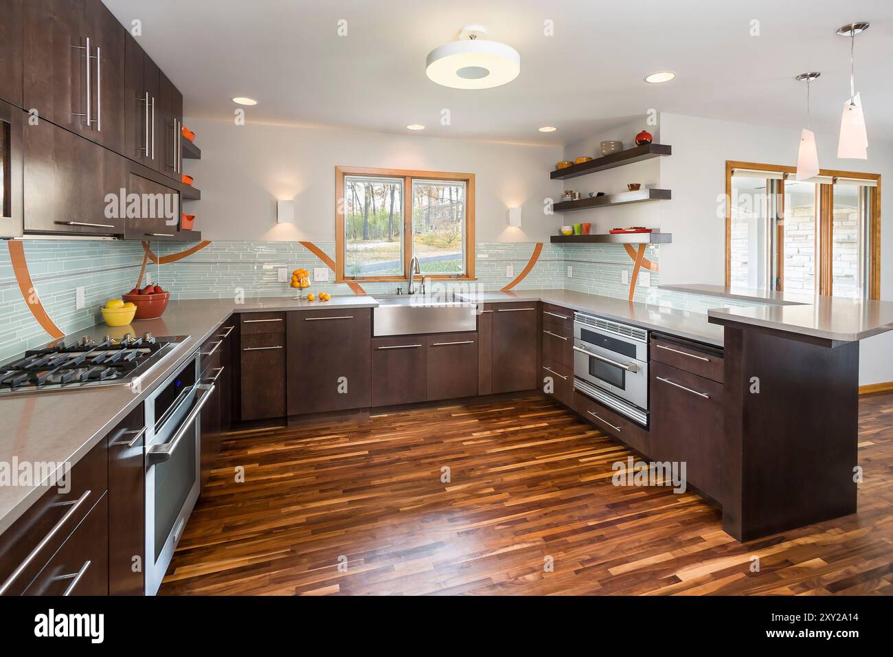 Modern kitchen with dark stained birch cabinets and colorful backsplash ...