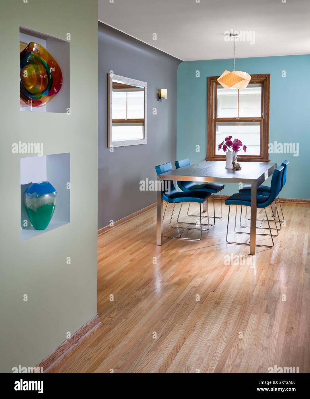 Colorful dining room with metal table and leather chairs Stock Photo