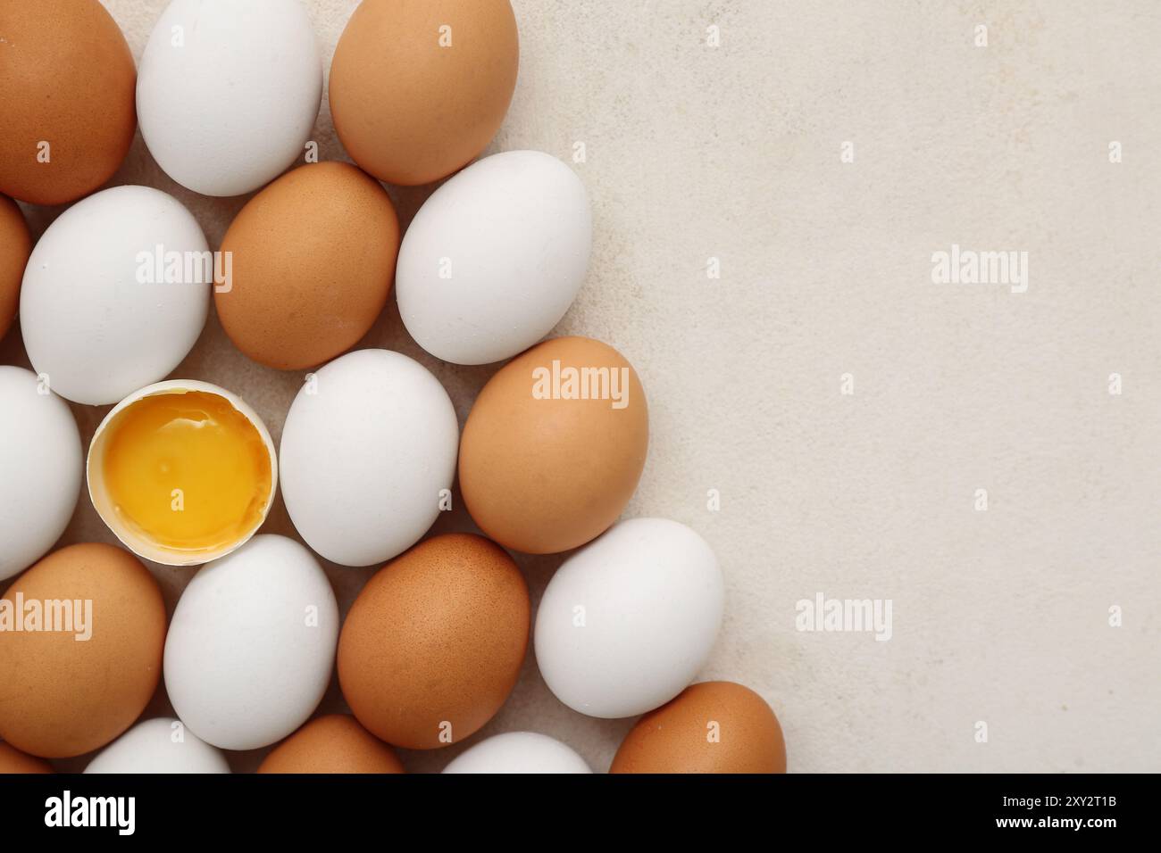 Cracked and whole chicken eggs on white background Stock Photo - Alamy